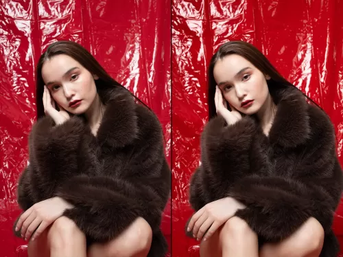 Студийный портрет девушки в меховой шубе на глянцевом красном фоне для модной рекламной съемки